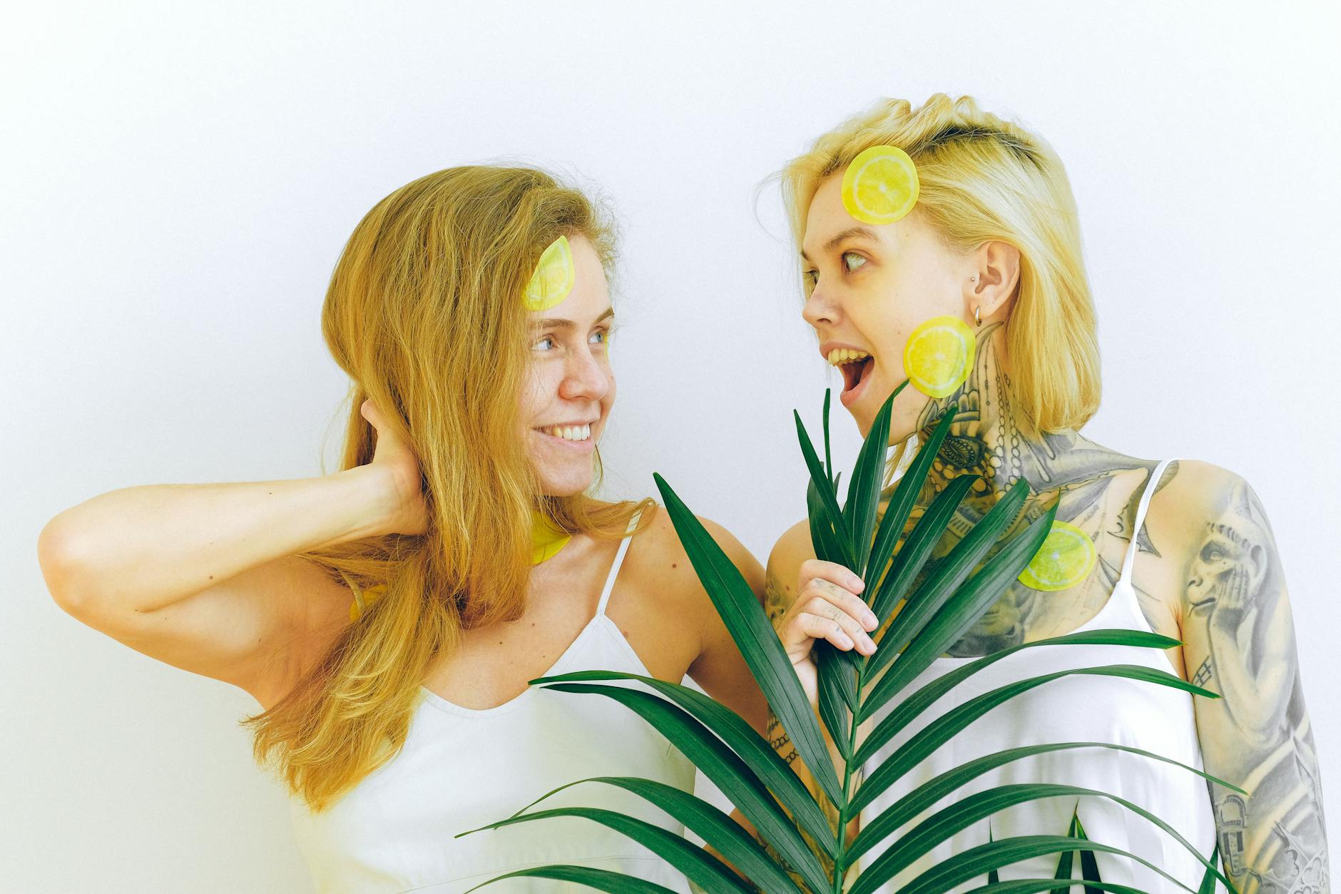 Two women smiling and laughing together indoors, representing connection and intimacy across distance