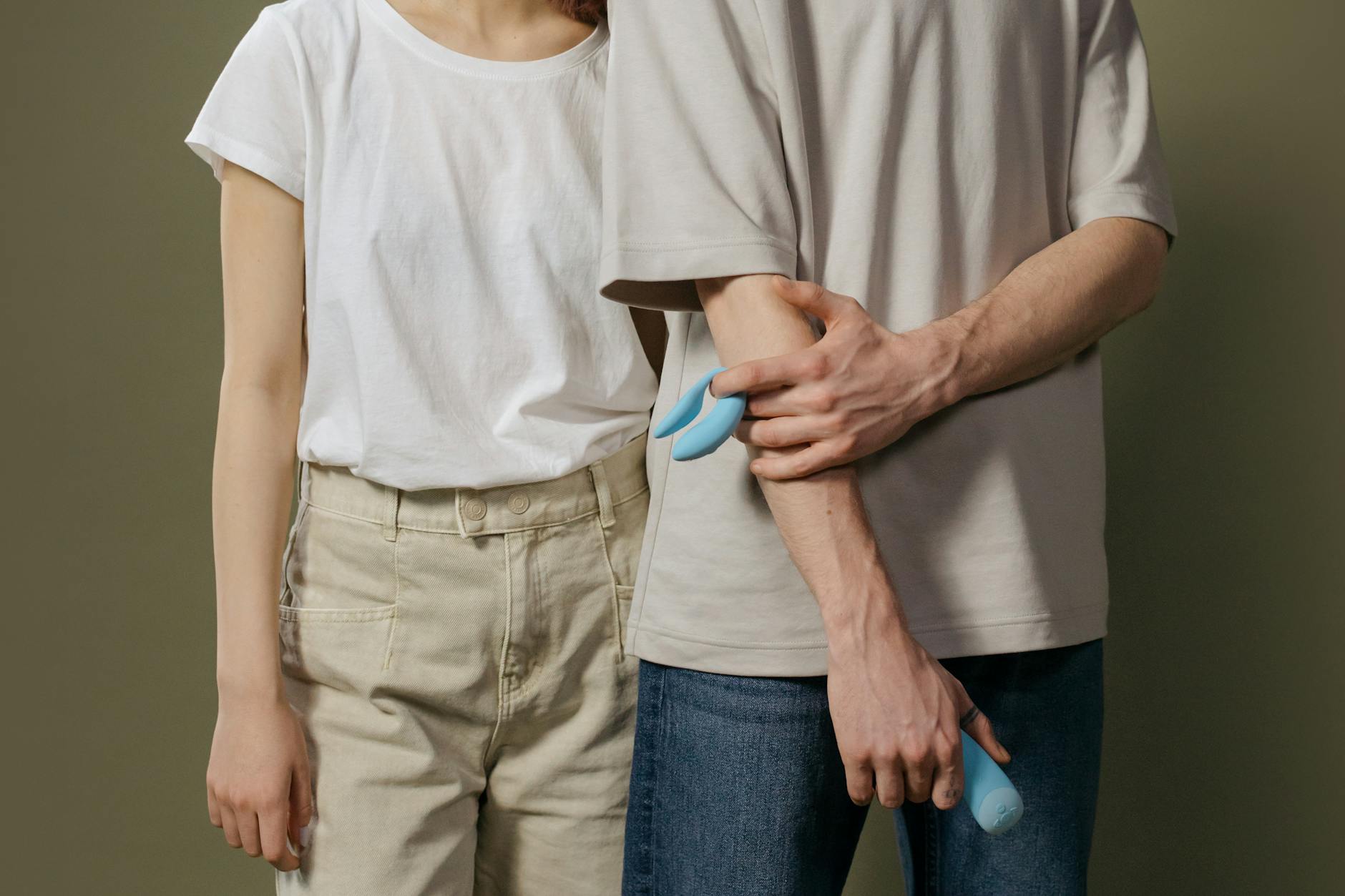A teal lemon vibrator resting on white silk fabric, representing calm and intentional pleasure.